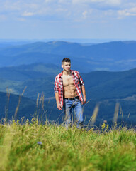 sexy and handsome. travelling adventure. hipster fashion. countryside concept. farmer on rancho. cowboy outdoor. sexy macho man in checkered shirt. man on mountain landscape. camping and hiking