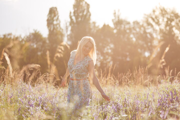 Close up of a woman's hand touching golden grass