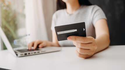 businesswoman hand using smart phone, tablet payments and holding credit card online shopping, omni channel, digital tablet docking keyboard computer at office in sun light