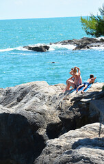 a family on the rocs in the summer