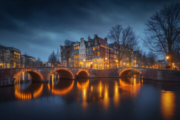 Fototapeta premium Amsterdam city canal old town, Netherlands. Beautiful iconic view illuminated at night