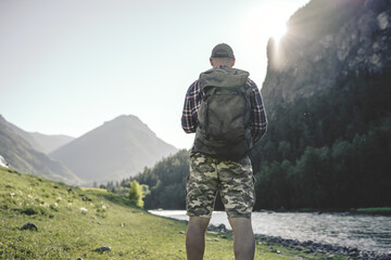 Fototapeta na wymiar men with backpack hiking in the mountains