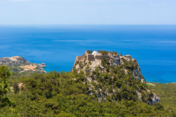 The castle of Monolithos located at the summit of the tall rock. Rhodes island, Greece