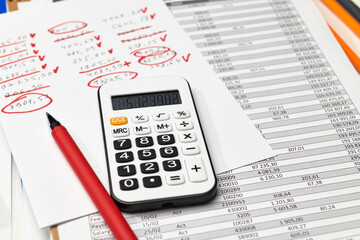 Top view of office employee's desk - work with financial reports, analysis and accounting, tables and graphs, various office items for bookkeeping