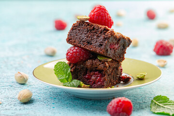 Traditional brownies with raspberries.