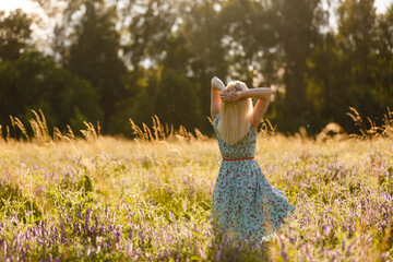 Healthy beautiful woman walking outdoors. Alluring young woman in wheat field, delicate sensual woman on nature. perfect skin, curly hair.