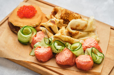 Russian pancakes with salmon and red caviar