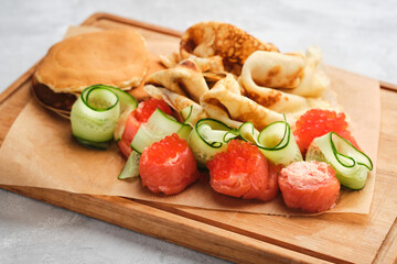 Russian pancakes with salmon and red caviar