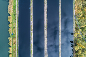 Abstract sendimentation tank of ironworks water treatment plant in Silesia Poland aerial drone view