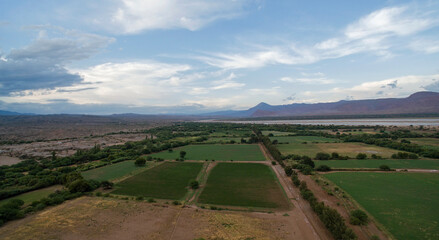 Fototapeta na wymiar Agriculture. Rural landscape. Aerial view of the alfalfa cultivation fields and farmland in the mountain valley.