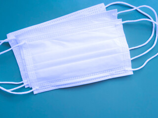 protective face mask on a blue background, surgical mask one time use, disposable
