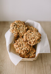 Homemade oats cookies with banana laid out in a box with parchment