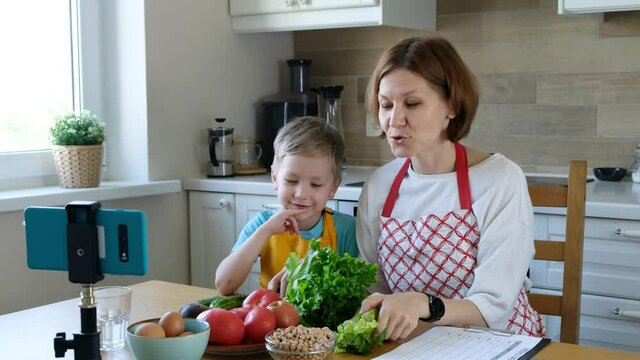 Food blogger woman and a child boy talking about healthy food to the camera, food vlog