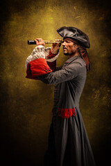 Portrait of a pirate, holding a spotting scope in his hands