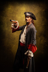 Portrait of a pirate, holding two musket pistol in his hands