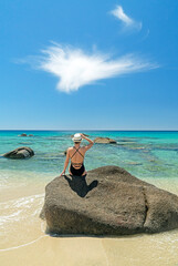 luxury trip to Sardinia. Woman with a hat on the beach in villasimius 