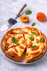 Apricot mascarpone tart, on blue background.