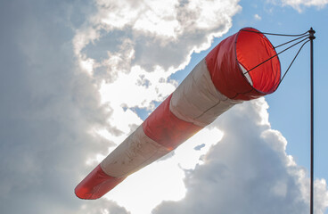 Windsock against the sky with clouds. Closeup.
