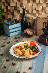 Crispy deep-fried chicken wings with greens 