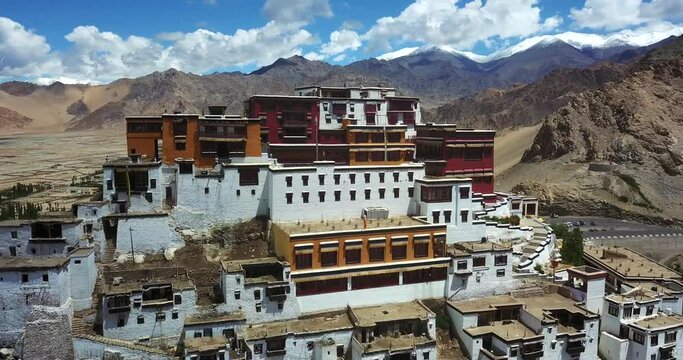 Down-looking aerial view of the buddhist monastery of Thiksey Gompa in the Leh valley of Ladakh, in the Himalayas, with its traditional village, famous religious destination in Northern India 