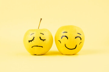 different emotions from happy smile joy to sadness and anger Face on an apples - abstract image of hide your human  emotions from others 