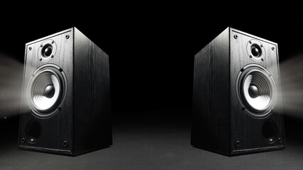 Two sound speakers with free space between them on black background.