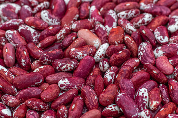 Top view of a heap of red beans. Raw red and white beans texture background. Close up.