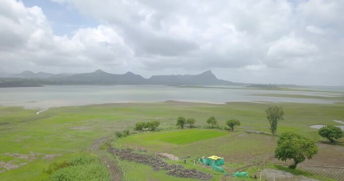 Flooded Paddy Fields, Lake and Mountains in rural India, Aerial