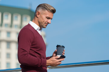 Living mobile lifestyle. Handsome man use mobile phone outdoors. Morning drink. Takeaway coffee....