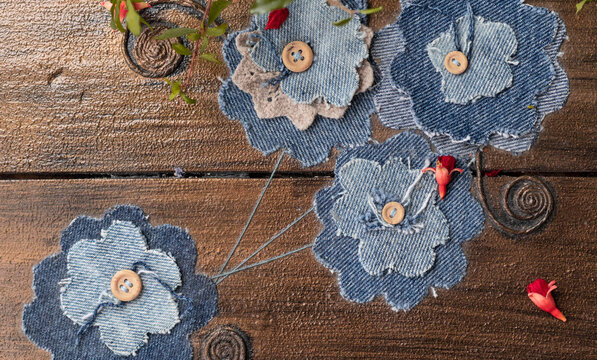 Flowers from old jeans decoration of the box. Concept of things reuse and natural resources preserving.