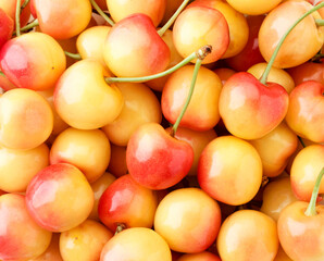 Red yellow sweet cherry close-up, background. The view from top