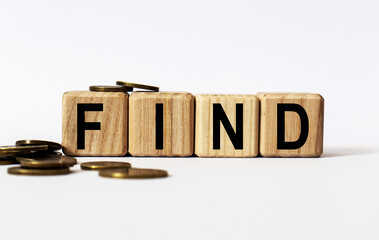 wooden cubes and FIND, coins, the concept of taxation, increase taxes and fees