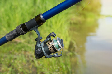 Fishing on the lake. Fishing rod on the background of the lake close-up. Fishing background.