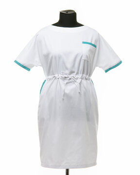 Female medical gown on a mannequin for clothes on a white background, front view