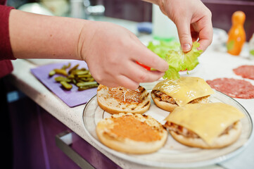 Сooking burgers in the kitchen at home during quarantine time.