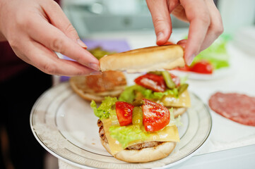 Сooking burgers in the kitchen at home during quarantine time.