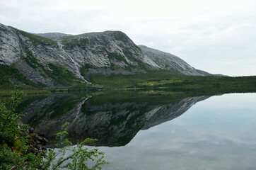 Fototapeta na wymiar reflective mountain lake in summer