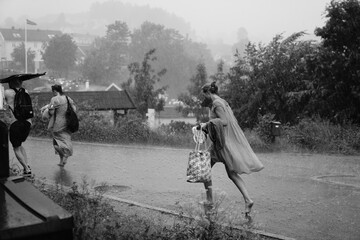 Running to seek shelter as it suddenly started to rain on a day that started out as sunny and clear.