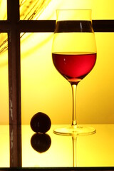 glass of red wine and bottle