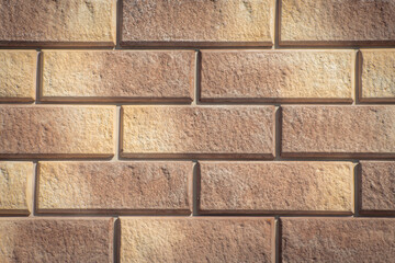 Texture of decorative bricks for finishing the facade of a house with a light brown shade