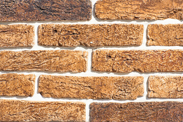 Texture of decorative bricks for finishing the facade of a house with a bronze shade
