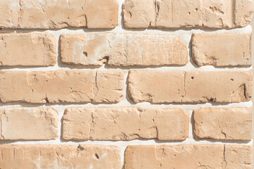 Texture of decorative bricks for finishing the facade of a house with a beige shade