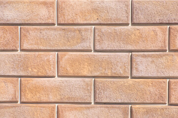 Texture of decorative bricks for finishing the facade of a house with a beige shade