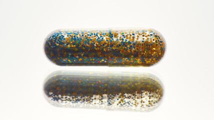 Creative concept with yellow, blue glitter pill isolated on white background. Minimal style, art concept