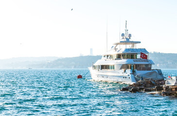 Large white modern yacht on the seafront in Istanbul.