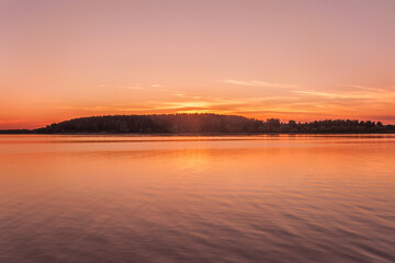 landscape sunset on the forest lake golden hour