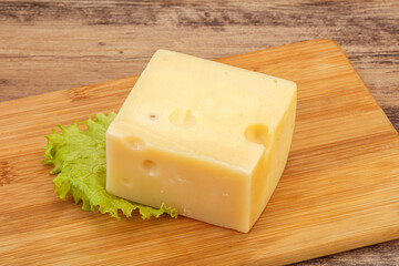 Emmental cheese over wooden board
