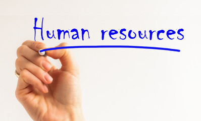 Hand with marker writing the word Human Resources. Hand writing inscription Human Resources with...