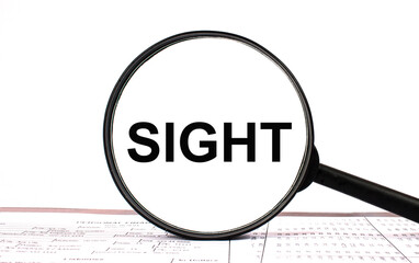 Magnifying glass with text SIGHT on financial tables