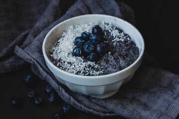 Blueberry porridge with coconut flakes